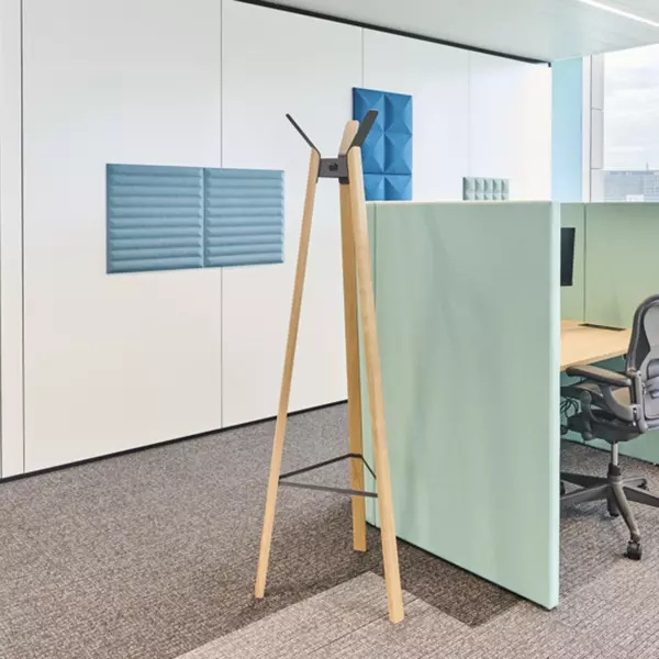 Workstation with office accessories such as coat rack, acoustic solutions, and carpet